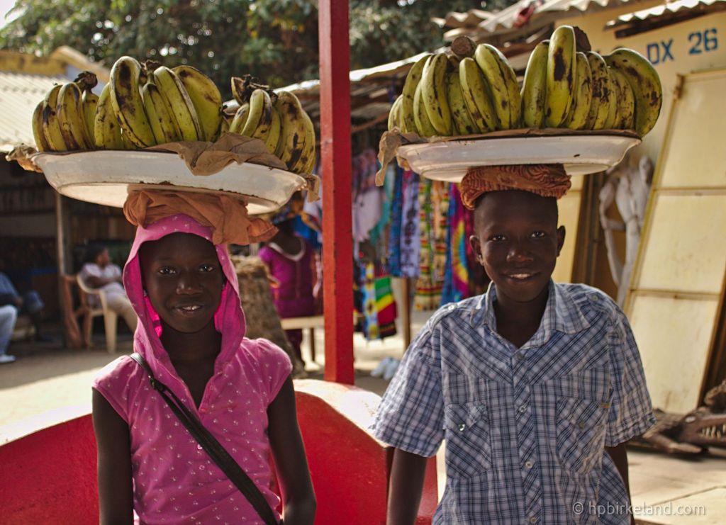 A boy and a girl selling bananas in the market in Banjul, Gambia.